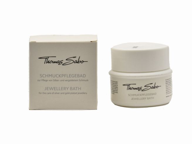 Schmuckpflegebad von Thomas Sabo in einem weißen Behälter mit einem dazugehörigen Karton, ideal zur Pflege von Silber- und vergoldetem Schmuck. Inhalt 150 ml.