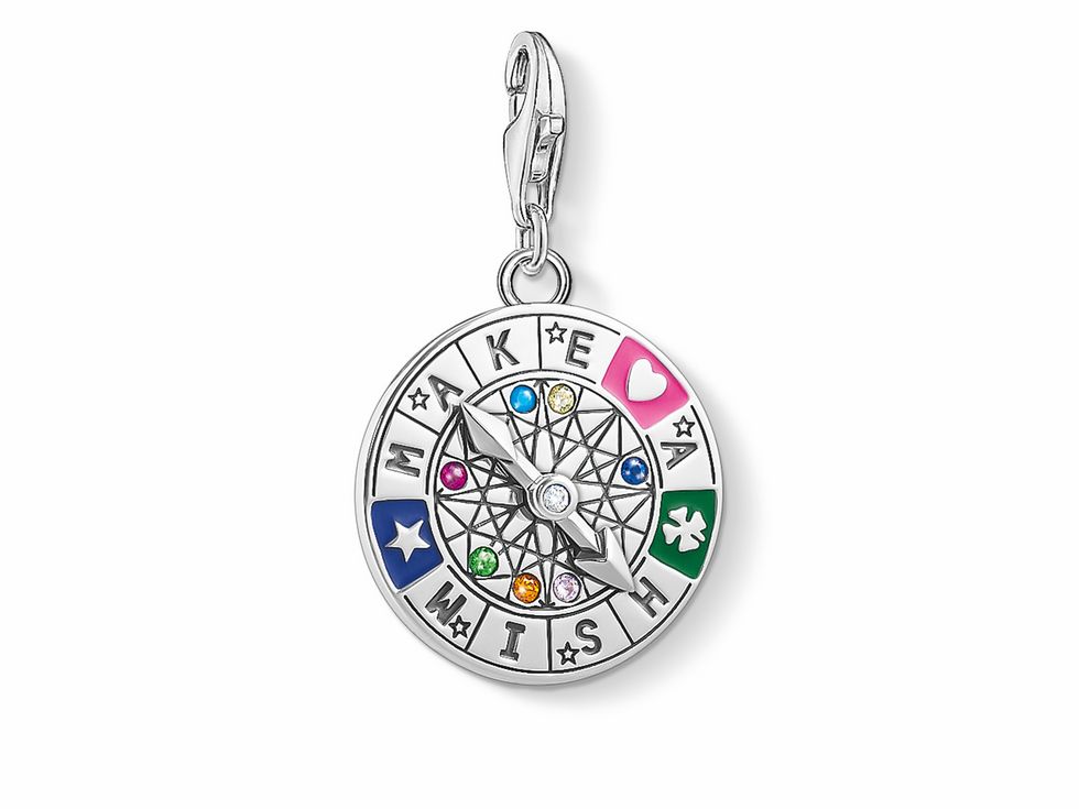 Thomas Sabo Charm-Anhänger 1818-340-7 aus Sterling Silber mit bunten Zirkonia. Das Design zeigt eine Kompassrose mit dem Schriftzug Make a Wish und verschiedenen Symbolen.