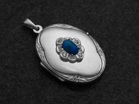 Howlite türkis Medaillon Cabochon in Sterling Silber rhodiniert, mit filigraner Verzierung und zentrale Halbedelsteinfassung, Hersteller Juwelier Harnisch, elegantes Schmuckstück.