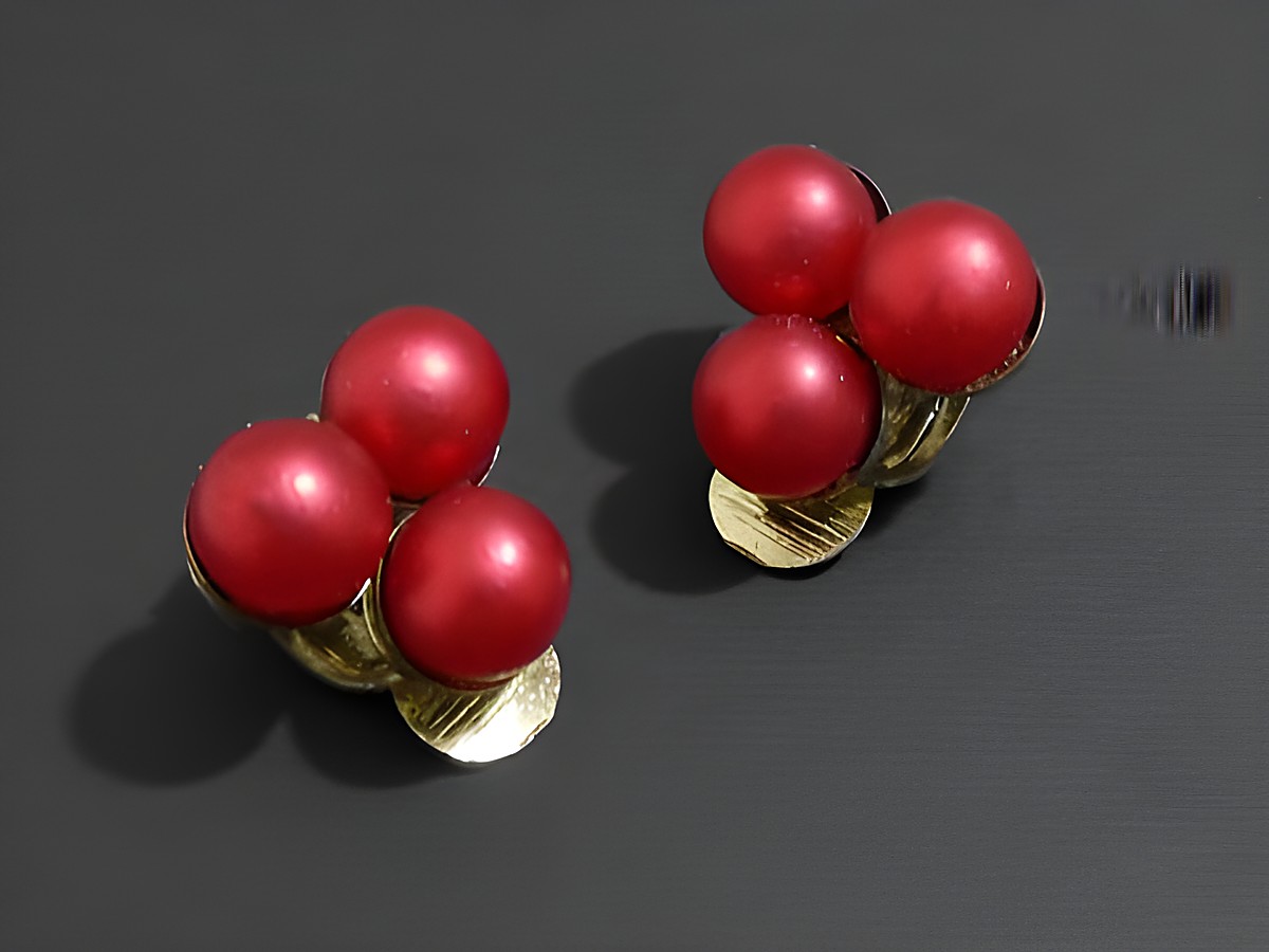 Modeschmuck Ohrclip elegant rot matt Zuchtperlenimitation von Juwelier Harnisch, mit zwei Gruppen aus jeweils zwei roten, matten Perlen und goldfarbener Klemmbasis.