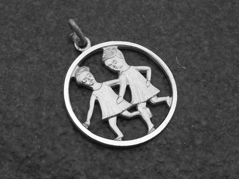 Silber Anhänger rund mit dem Sternzeichen Zwillinge, gefertigt vom Juwelier Harnisch, zeigt zwei figurative Darstellungen in einem geschlossenen Kreis.