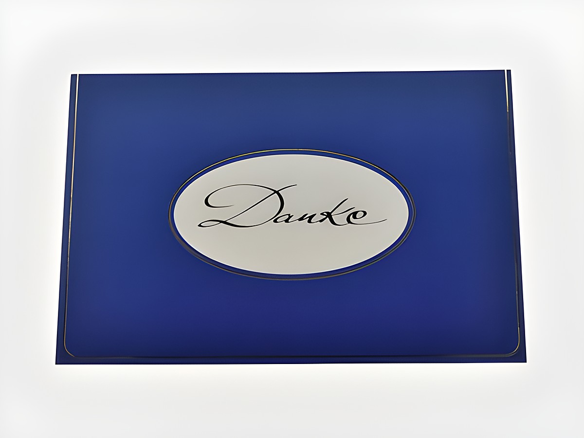 Blau gestaltete Dankeskarte mit goldener Schrift auf weißem Oval. Hersteller Juwelier Harnisch. Elegantes Design für verschiedene Anlässe.