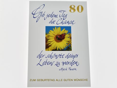 Geburtstagskarte mit buntem Design, zeigt eine Sonnenblume und den Spruch "Gib jedem Tag die Chance der schönste deines Lebens zu werden" von Mark Twain, Hersteller Juwelier Harnisch.