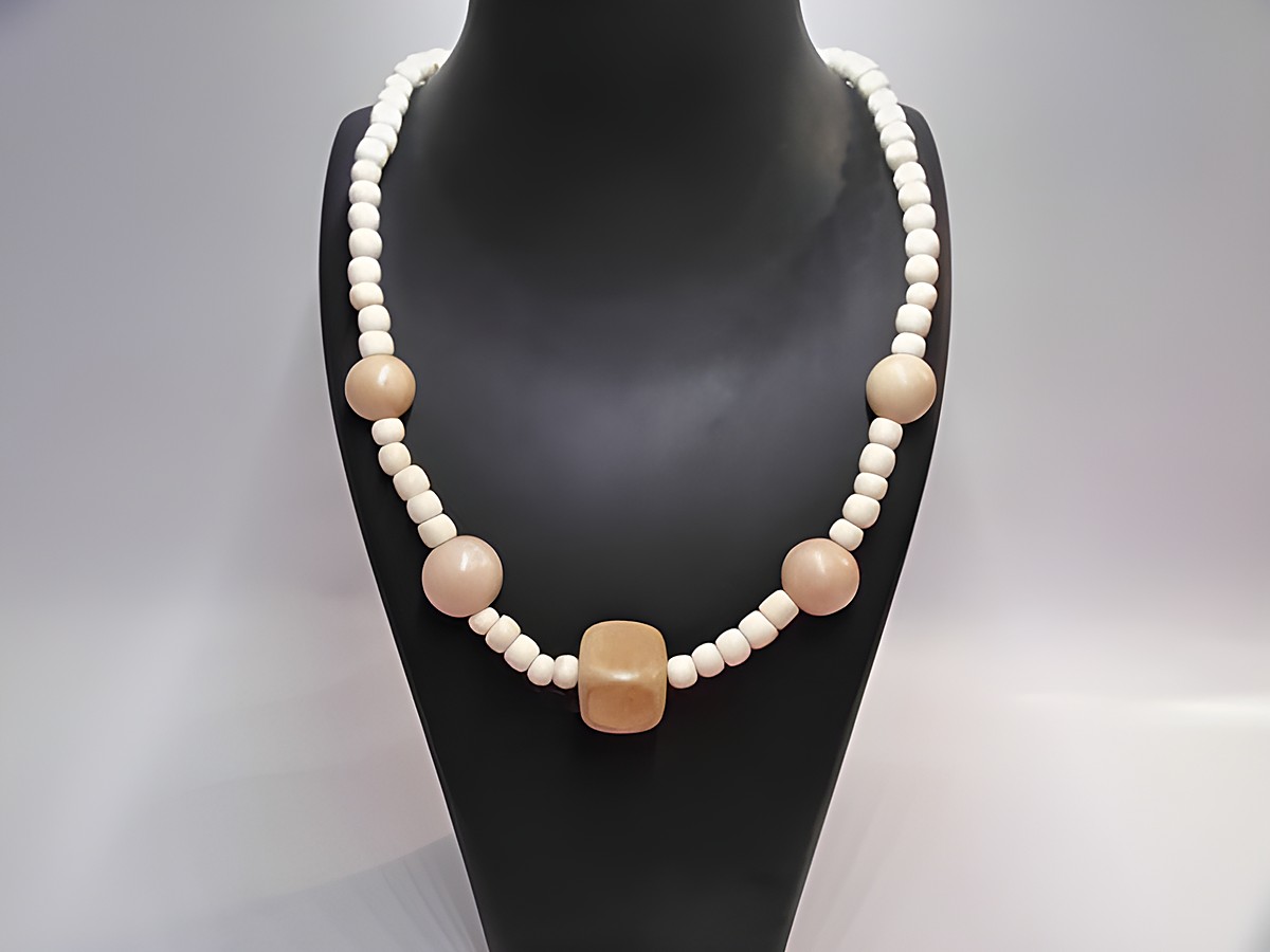 Holzkette Multiform 19 mm naturbraun 60 cm Holz Schmuck von Juwelier Harnisch, bestehend aus verschiedenen Holzperlen und einem zentralen quadratischen Element in naturbraun.