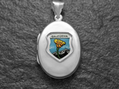 Silbermedaillon mit dem Schriftzug California und einer Abbildung einer gelben Blume vor einem Bergpanorama, Hersteller Juwelier Harnisch, geeignet für Sammler und Anhänger von Weltmedaillons.