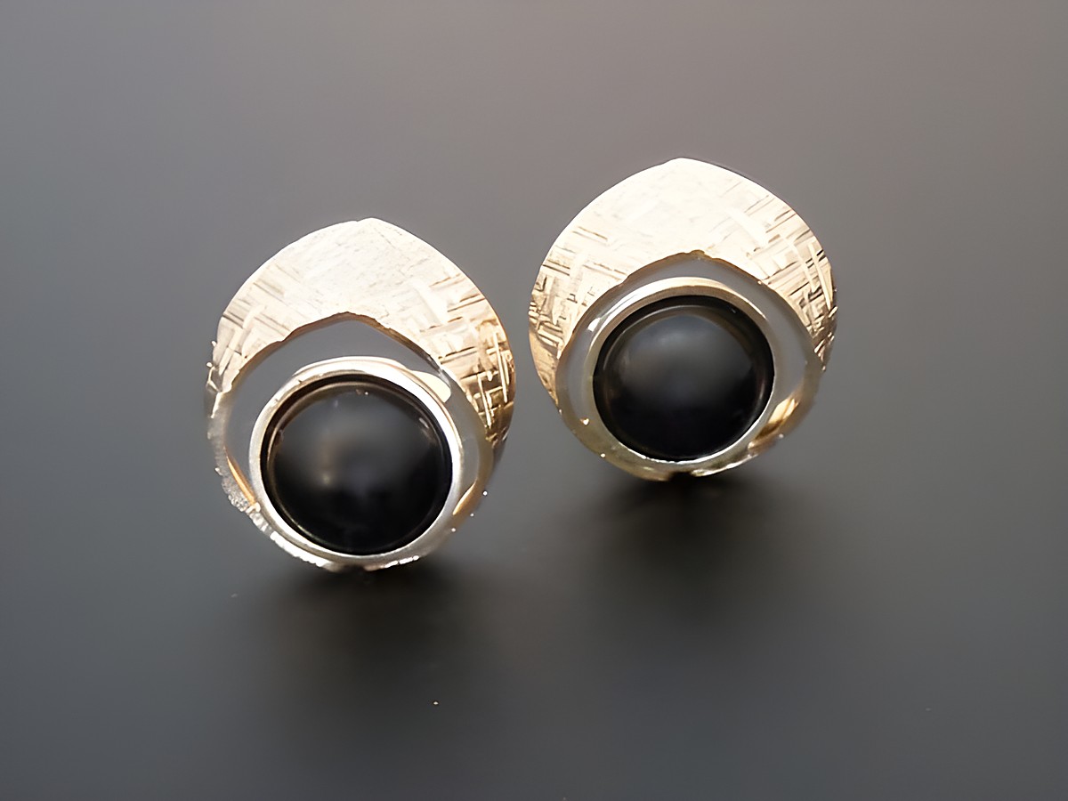 Ohrclip in goldfarben mit zeitlosem Design, echt Onyx und echter Goldauflage, Hersteller Juwelier Harnisch, elegantes Schmuckstück für besondere Anlässe.