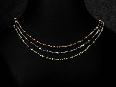 Silber Kette Rundanker Kugelkette tricolor rhodiniert 42 cm von Juwelier Harnisch mit mehreren Reihen und Kugeln in Gold, Silber und Roségold auf einem dunklen Hintergrund.