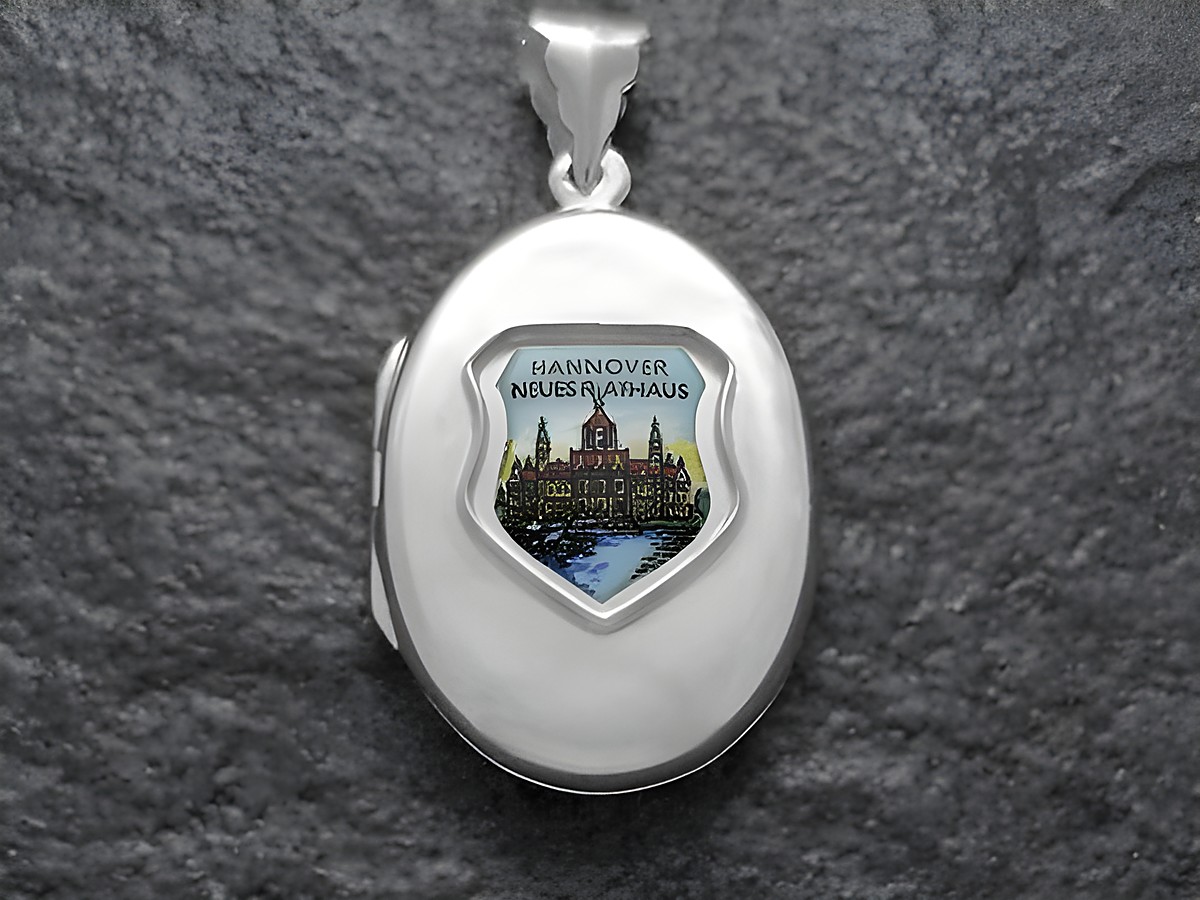 Silbernes Medaillon mit dem Motiv des Neuen Rathauses in Hannover, Niedersachsen, umgeben von einem Schild. Hersteller: Juwelier Harnisch.