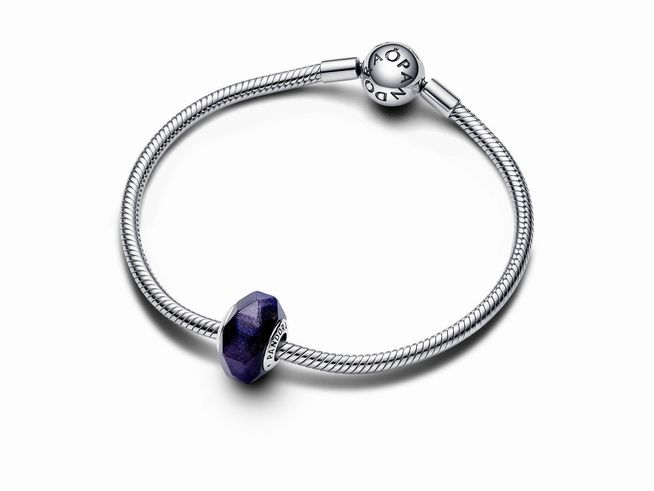 Facettiertes Blaues Murano-Glas-Charm aus Sterling Silber von Pandora, eingebettet in einem eleganten Armband, das durch sein strahlendes Blau besticht und stilvolle Akzente setzt.