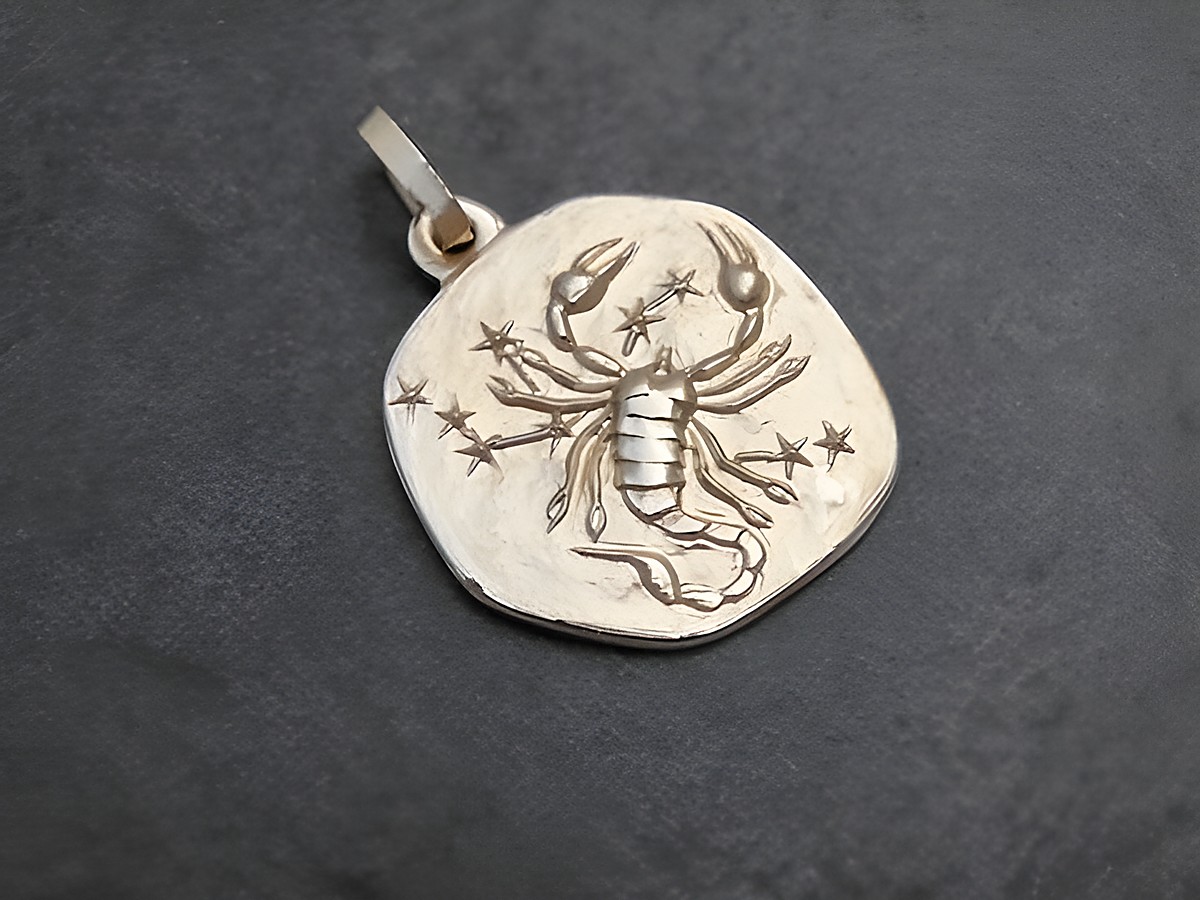 Anhänger aus Gold mit dem Motiv des Sternzeichens Skorpion, gestaltet vom Juwelier Harnisch, zeigt einen detaillierten Skorpion umgeben von kleinen Sternen.