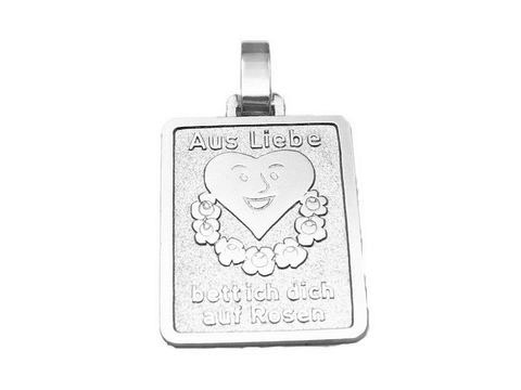 Silber Anhänger mit dem Motiv Aus Liebe bette ich Dich auf Rosen, gefertigt von Juwelier Harnisch, zeigt ein Herz umgeben von Blumen und lächelndem Gesicht.
