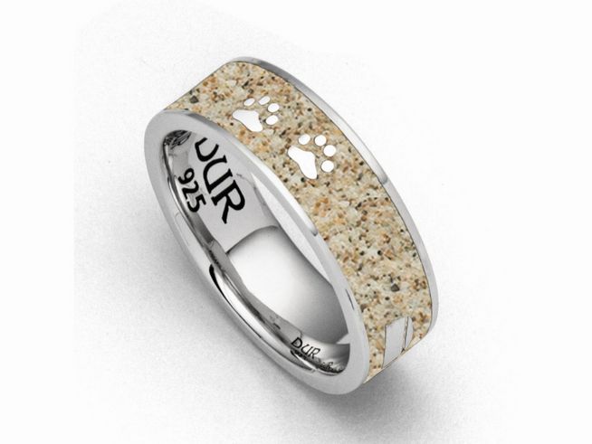 Ein silberner Ring von DUR mit einer sandfarbenen Fläche und Pfotenabdrücken. Der Ring hat die Größe 54 und ist aus sterling Silber gefertigt. Elegant und einzigartig im Design.