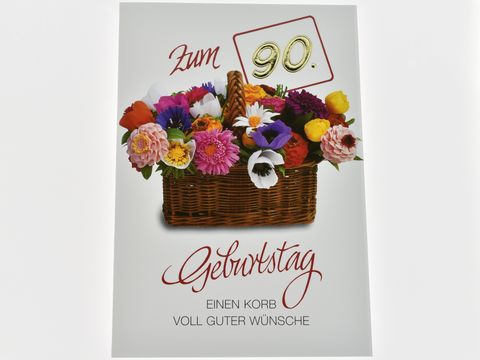 Blumenkorb mit bunten Blumen auf einer Geburtstagskarte zum 90. Geburtstag, darunter der Schriftzug einen Korb voll guter Wünsche, Hersteller Juwelier Harnisch, Geburtstagskarten.