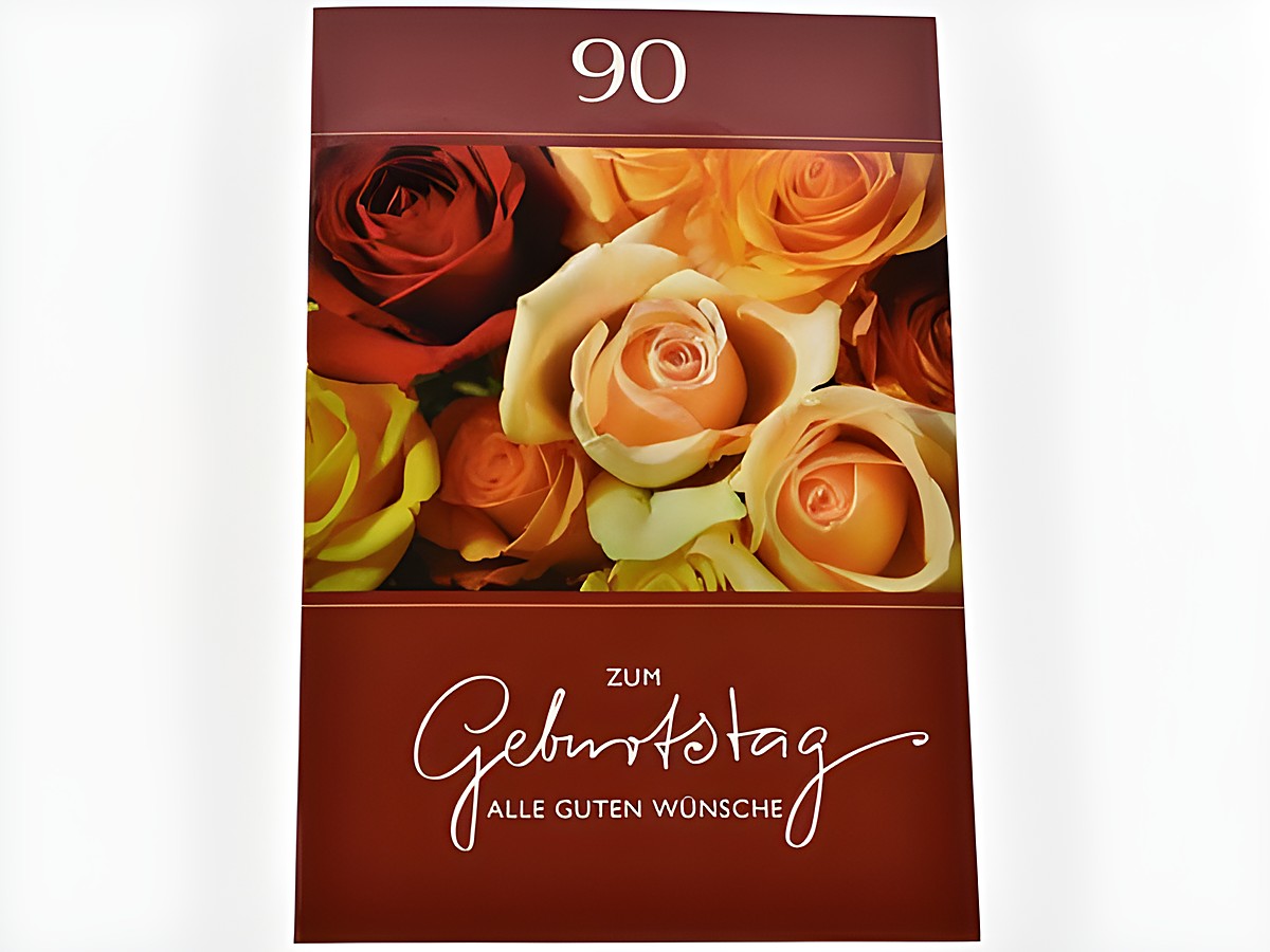 Eine Geburtstagskarte mit der Aufschrift zum Geburtstag alle guten Wünsche und der Zahl 90, umgeben von bunten Rosenblüten in verschiedenen Farben. Hersteller: Juwelier Harnisch, Geburtstagskarten.