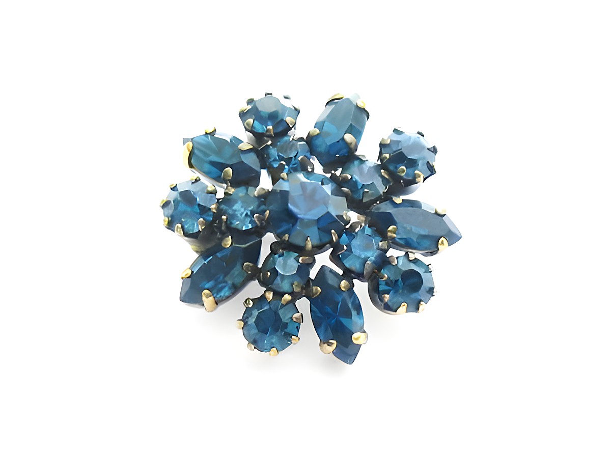 Blaue Strass Brosche im sexy City Look, rund, hergestellt von Juwelier Harnisch, mit funkelnden blauen Steinen in verschiedenen Formen, ideal für stilvolle Akzente.