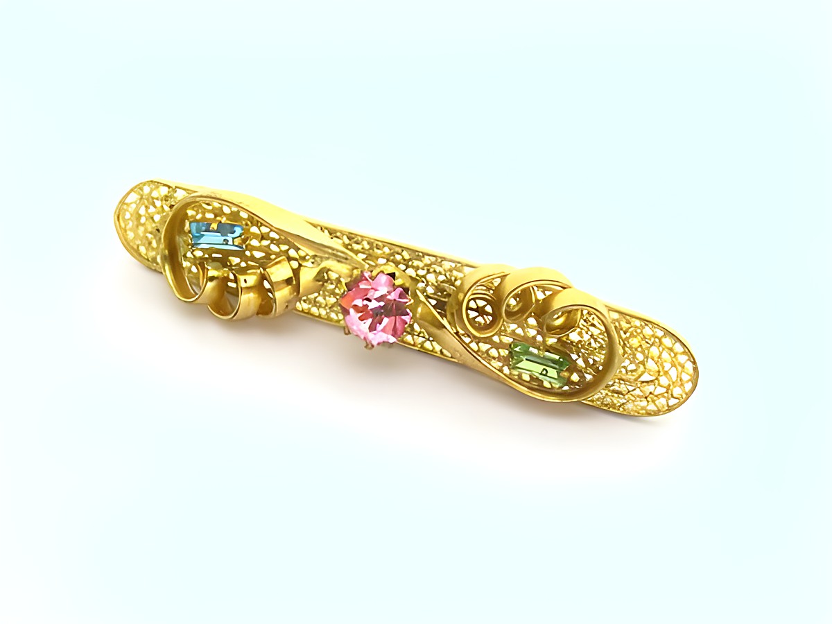 Strass Brosche - Wunderschön - Bunt & Gefasst - NEU - Hersteller: Juwelier Harnisch, eine elegante goldene Brosche mit bunten Strasssteinen in verschiedenen Farben.