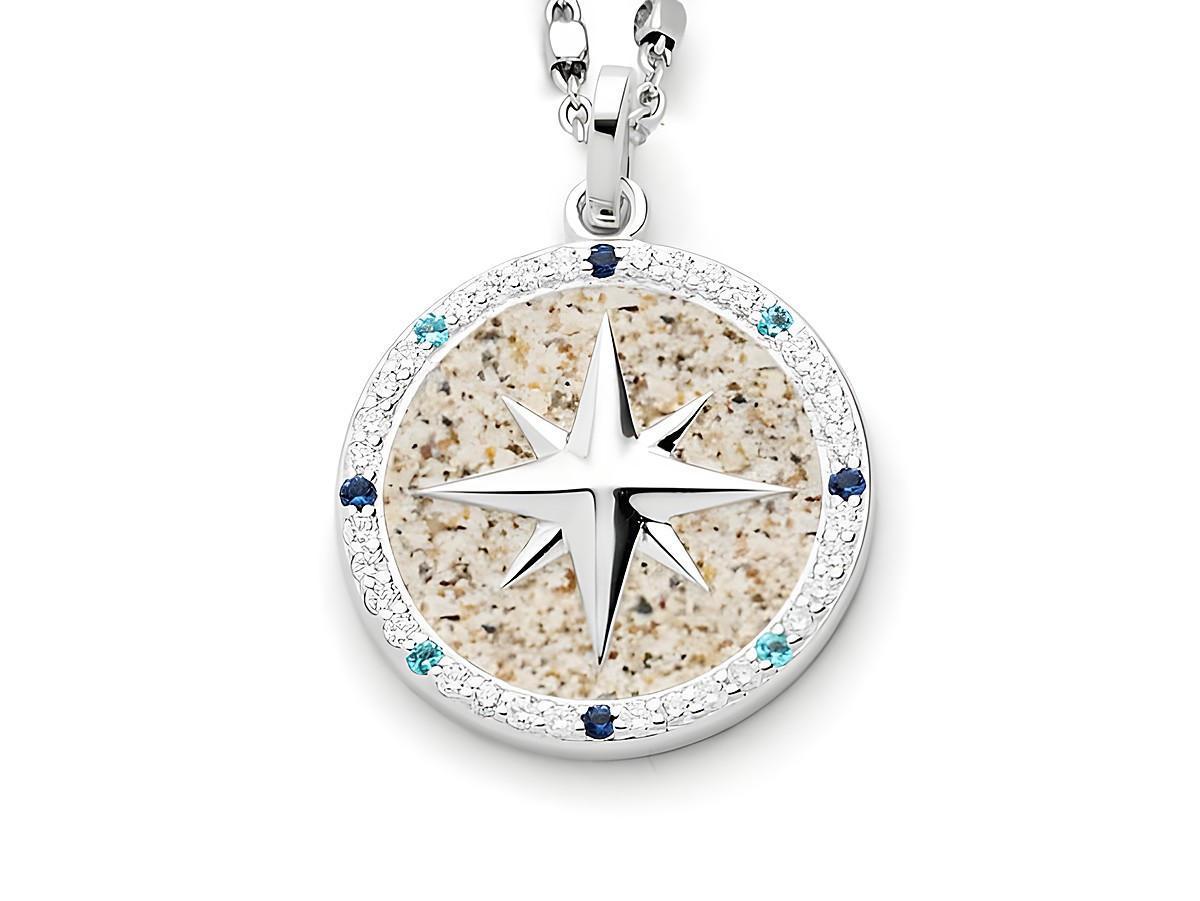 DUR Anhänger Kompassrose 2.0 aus Sterlingsilber mit einem zentralen, sternförmigen Element und einem kreisförmigen Rand aus bunten, funkelnden Steinen.