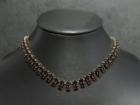 Charmante Strass Kette in granatrot mit goldfarbener Fassung, spezifische Länge von 40 bis 43,5 cm, hergestellt von Juwelier Harnisch. Ideal für elegante Anlässe.