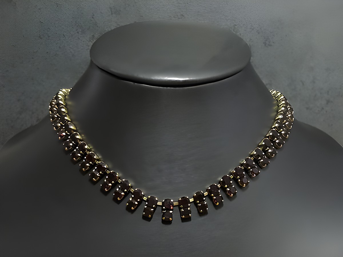 Charmante Strass Kette in granatrot mit goldfarbener Fassung, spezifische Länge von 40 bis 43,5 cm, hergestellt von Juwelier Harnisch. Ideal für elegante Anlässe.