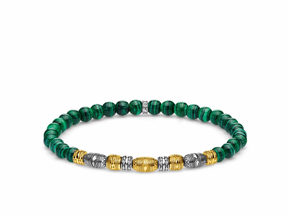 Ein Thomas Sabo Armband mit einer Länge von 17 cm, gefertigt aus hochwertigem Sterling Silber, vergoldet in Gelbgold, verziert mit grünem, imitierten Malachit und dekorativen Elementen in verschiedenen Farben.