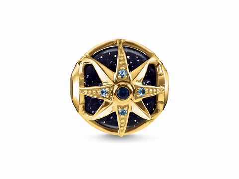 Karma Beads von Thomas Sabo mit Stein, in goldener Farbe, zeigt einen Kompass mit blauen Steinen, elegant und detailreich gestaltet, ideal für individuelle Schmuckstücke.