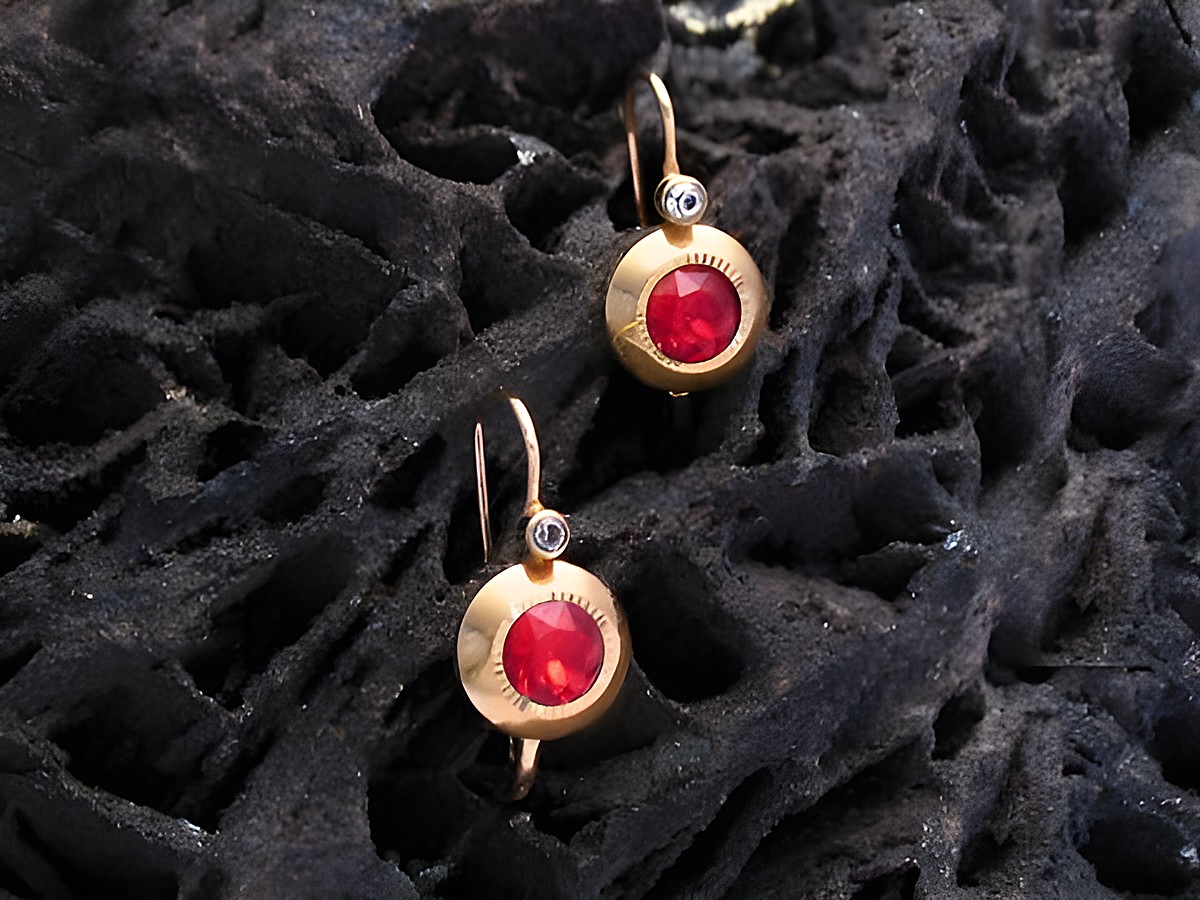 Ohrringe mit rot facettiertem Stein in Gold, Hersteller Juwelier Harnisch, elegante Ohrhänger mit zeitlosem Design und funkelndem Akzent für jeden Anlass.