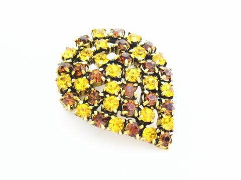 Gelbe Strass Brosche im sexy City Look in Blattform, hergestellt von Juwelier Harnisch, verziert mit gelben und braunen Strasssteinen.