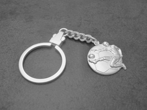 Schlüsselanhänger Fußball aus echtem Silber, gefertigt von Juwelier Harnisch, zeigt einen spielenden Fußballer auf einem Fußball, ideale Geschenkidee für Fußballfans.