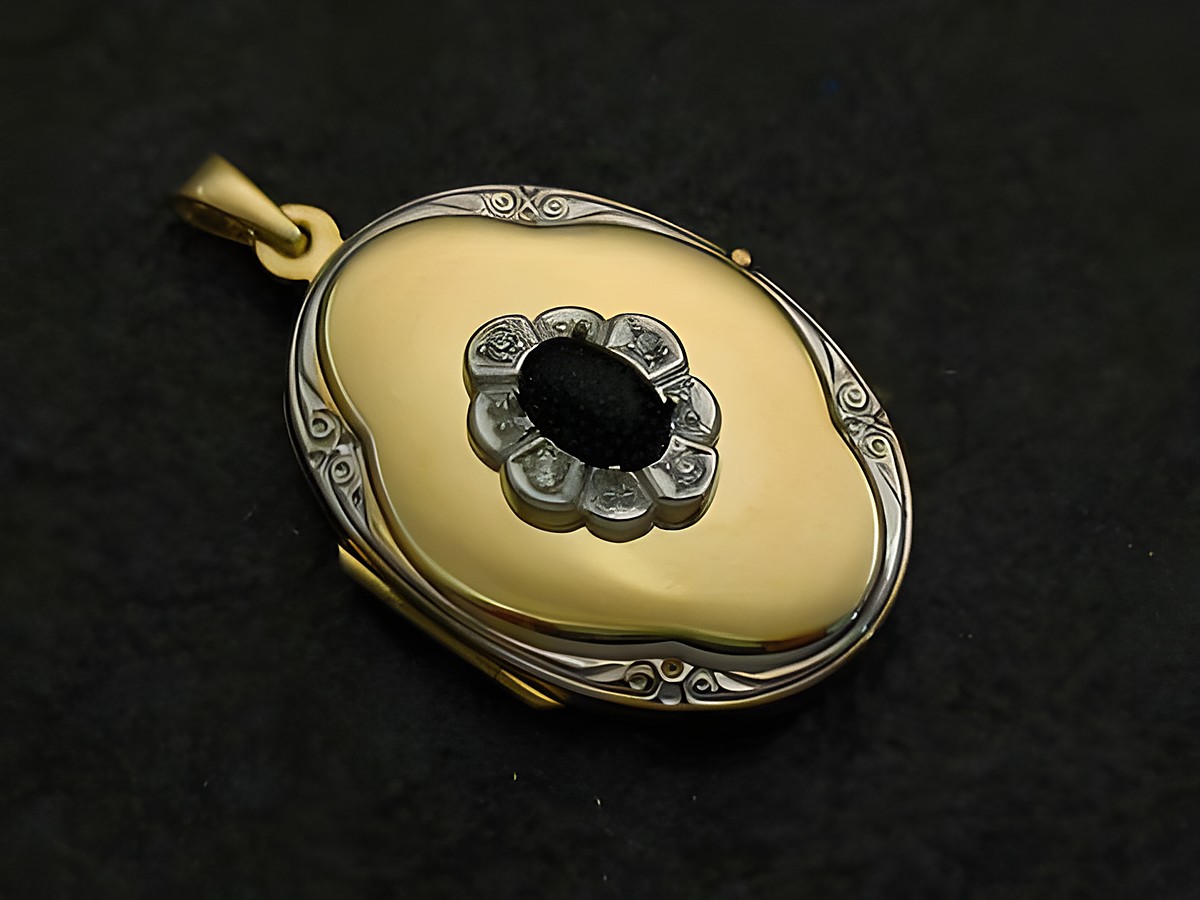 Medaillon Cabochon Gold 585 bicolor von Juwelier Harnisch, ovales Design mit schwarzem Einsatz und diamantierter Umrandung, edel und zeitlos.