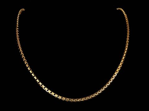 Lange Kette XXL vergoldet Venezia Kette 3 x 3 mm 85 cm von Juwelier Harnisch zeigt eine elegante und schimmernde Kette auf schwarzem Hintergrund.