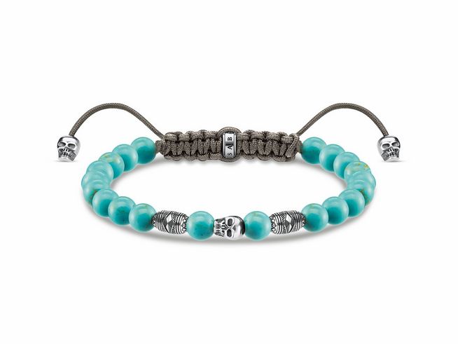 Armband von Thomas Sabo aus Sterling Silber mit geschwungenen Totenköpfen und Imitationen in Türkis, verstellbar von 16 cm bis 22 cm, mit robustem Nylon und charakteristischem Design.