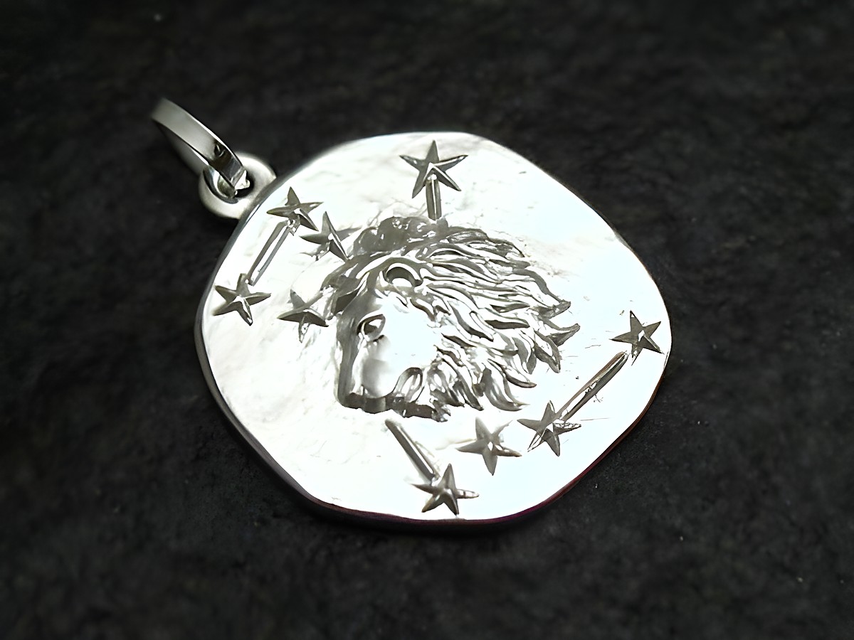 Löwe Sternzeichen Anhänger aus Sterling Silber hergestellt von Juwelier Harnisch mit einem detaillierten Löwenkopf und umgebenden Sternen.