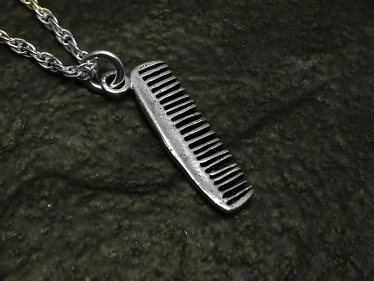 Ein feiner Kamm aus Sterling Silber als Anhänger, hergestellt von Juwelier Harnisch, ideal für Stilbewusste und Friseure als modisches Accessoire.