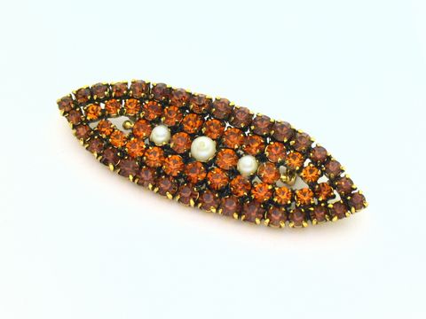 Strass Brosche oval in Braun und Gelb, gefasst mit Perlen, neu vom Hersteller Juwelier Harnisch. Ideal als elegantes Accessoire für verschiedene Anlässe.