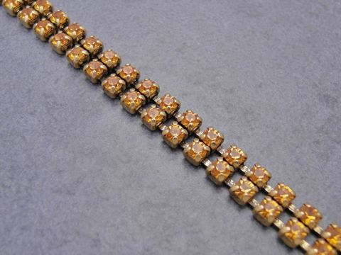 Strass Armband in verführerischem Orange, gefertigt aus hochwertigem Strassschmuck, verstellbar von 19,5 bis 21,5 cm, Hersteller Juwelier Harnisch, ideal für elegante Anlässe.