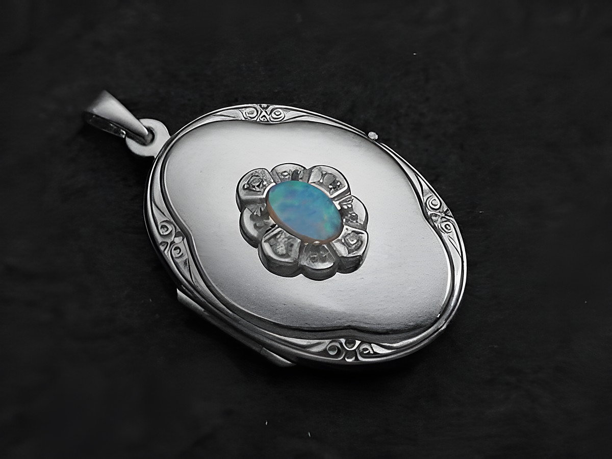 Ein elegantes Medaillon aus Weißgold 333 mit einem ovalen, hellblauen Opal-Cabochon in der Mitte, umgeben von Brillanten, gefertigt vom Juwelier Harnisch.
