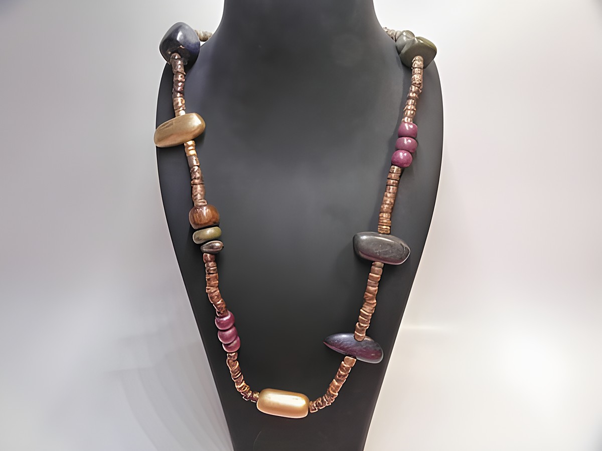 Bunte Holzkette mit einer Länge von 90 cm und einer Breite von 30 mm, gefertigt von Juwelier Harnisch, bestehend aus verschiedenen farbigen Holzperlen.