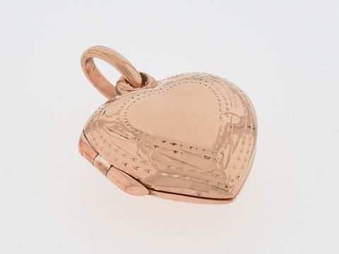 Silber Medaillon in Herzform, silber rosé vergoldet mit filigranem Rand, Hersteller Juwelier Harnisch. Elegantes Schmuckstück für besondere Anlässe.