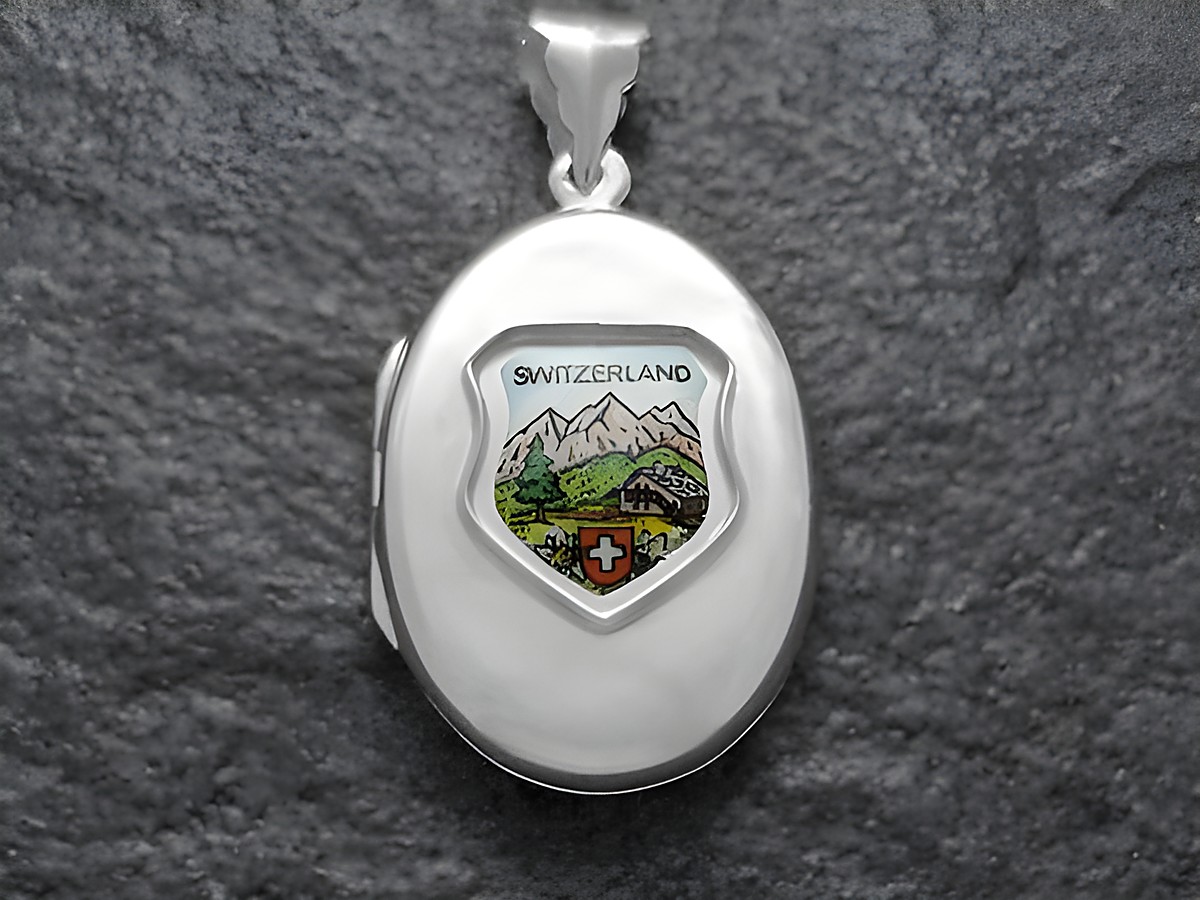 Silbermedaillon mit einem Wappen, das die Schweizer Alpen und die Aufschrift Switzerland zeigt, Hersteller Juwelier Harnisch, Europa Medaillons.