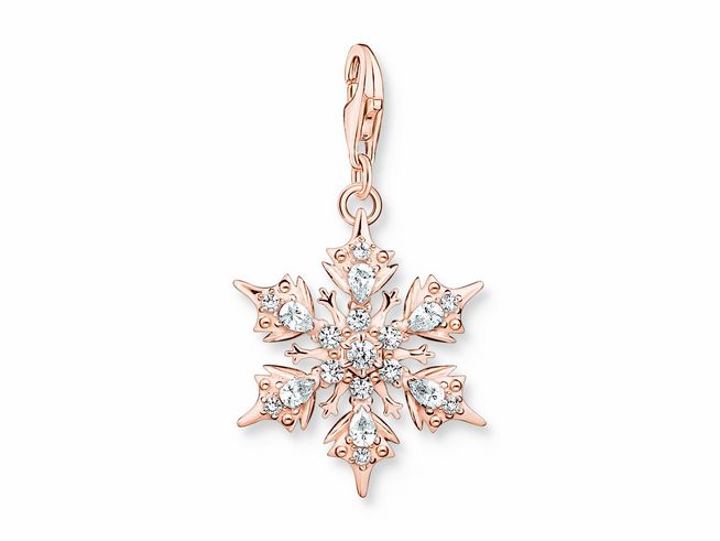 Charm-Anhänger in Form einer Schneeflocke aus Sterling Silber, vergoldet in Roségold, verziert mit Zirkonia. Elegantes Design für jedes Schmuckstück. Hersteller Thomas Sabo.