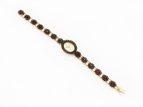 Granat Schmuck Uhr 18 cm mit goldenen Blüten aus Granatschmuck, Hersteller Juwelier Harnisch, verziert mit Stein und Perle, eleganter Zeitmesser im klassischen Design.