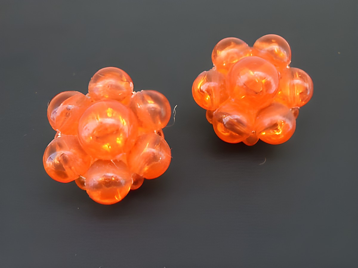 Ohrclip in orange mit blumigem Design, goldfarbene Synth. Zuchtperle, Hersteller Juwelier Harnisch, eleganter Ohrclip für stilvolle Akzente.