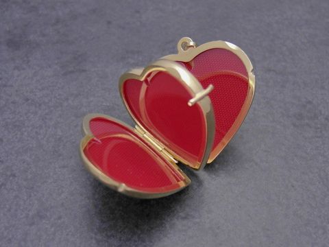 Herz Medaillon aus poliertem Gold 750, öffnend, mit rotem Innenraum, geeignet für 4 Bilder, Hersteller Juwelier Harnisch, elegantes und romantisches Schmuckstück.
