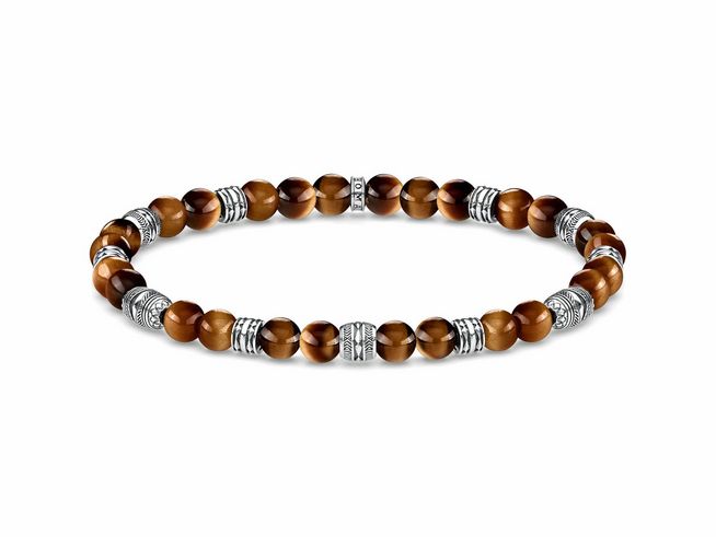 Ein elegantes Armband von Thomas Sabo aus Sterling Silber mit Tigerauge. Es besteht aus runden Perlen und geschwungenen silbernen Elementen. Die Länge beträgt 15,5 cm und ist bis 16 cm verstellbar.