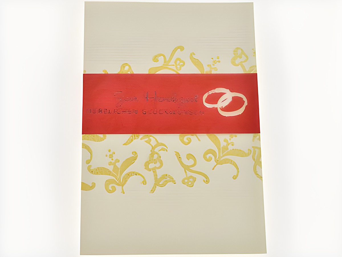 Hochzeitskarte mit goldenen Ornamenten, eine rote Banderole mit dem Text zur Hochzeit und den Eheringen, hergestellt von Juwelier Harnisch, ideal für Glückwünsche zur Hochzeit.