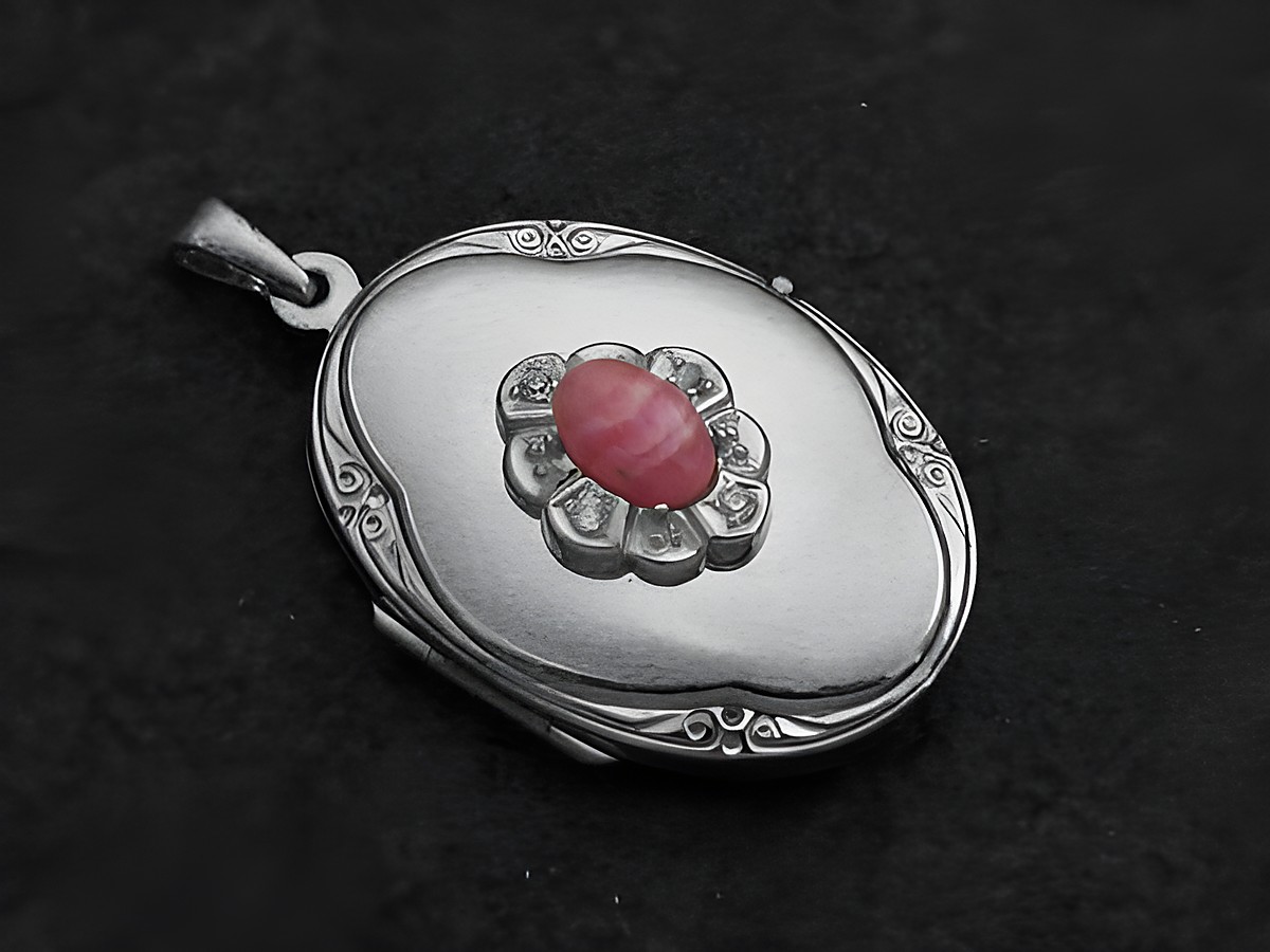Rhodochrosit Medaillon Cabochon in Sterling Silber mit Brillanten, elegant gefasst und verziert, Hersteller Juwelier Harnisch, ideal als Schmuckstück für besondere Anlässe.