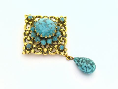 60345-0 Wunderschöne Brosche in türkis und gefasst, neu vom Hersteller Juwelier Harnisch, mit einem eleganten Design und einer Tropfenform, ideal für einen edlen Look.