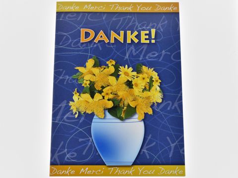 Dankeskarten mit der Aufschrift Danke und einem bunten Strauß gelber Blumen in einer blauen Vase, hergestellt von Juwelier Harnisch, in einem ansprechenden Design.