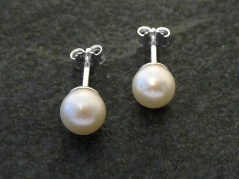 Perlenohrringe mit Zuchtperlen in 7 mm Durchmesser, gefertigt aus Sterling Silber, präsentiert auf dunklem Hintergrund, stilvoll und elegant, ideal für besondere Anlässe.
