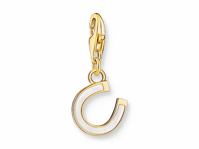 Charm-Anhänger in Form eines Hufeisens aus Silber mit vergoldeten Akzenten und kaltemail in Weiß, ideal für individuelle Schmuckdesigns, erhältlich bei Thomas Sabo.